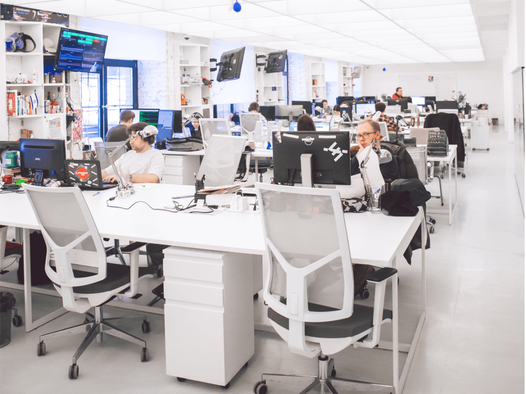 A modern looking office with staff concentrated on their computers