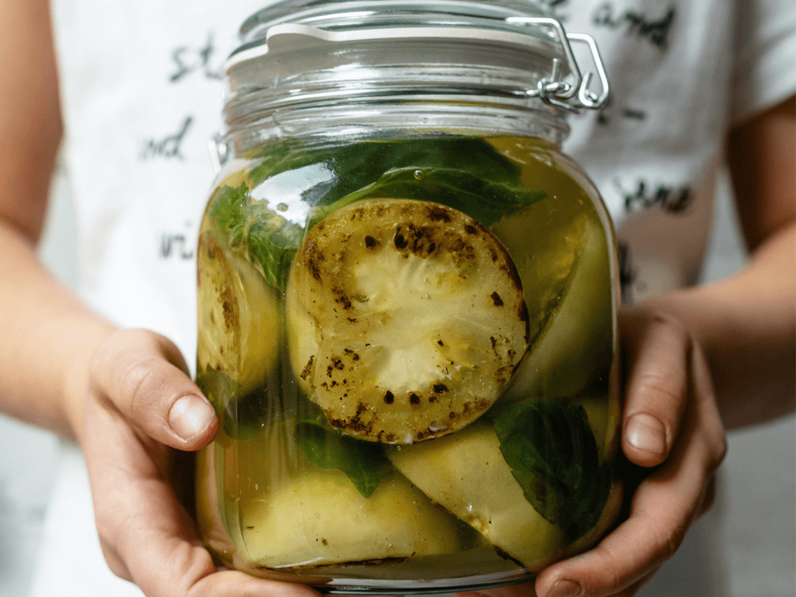 A large jar of homemade pickled produce