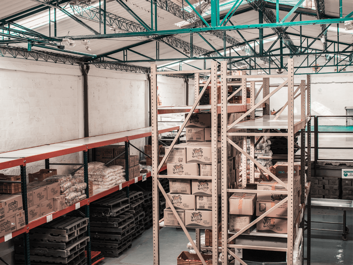 Interior of a packaging warehouse with shelves stocked with cardboard boxes