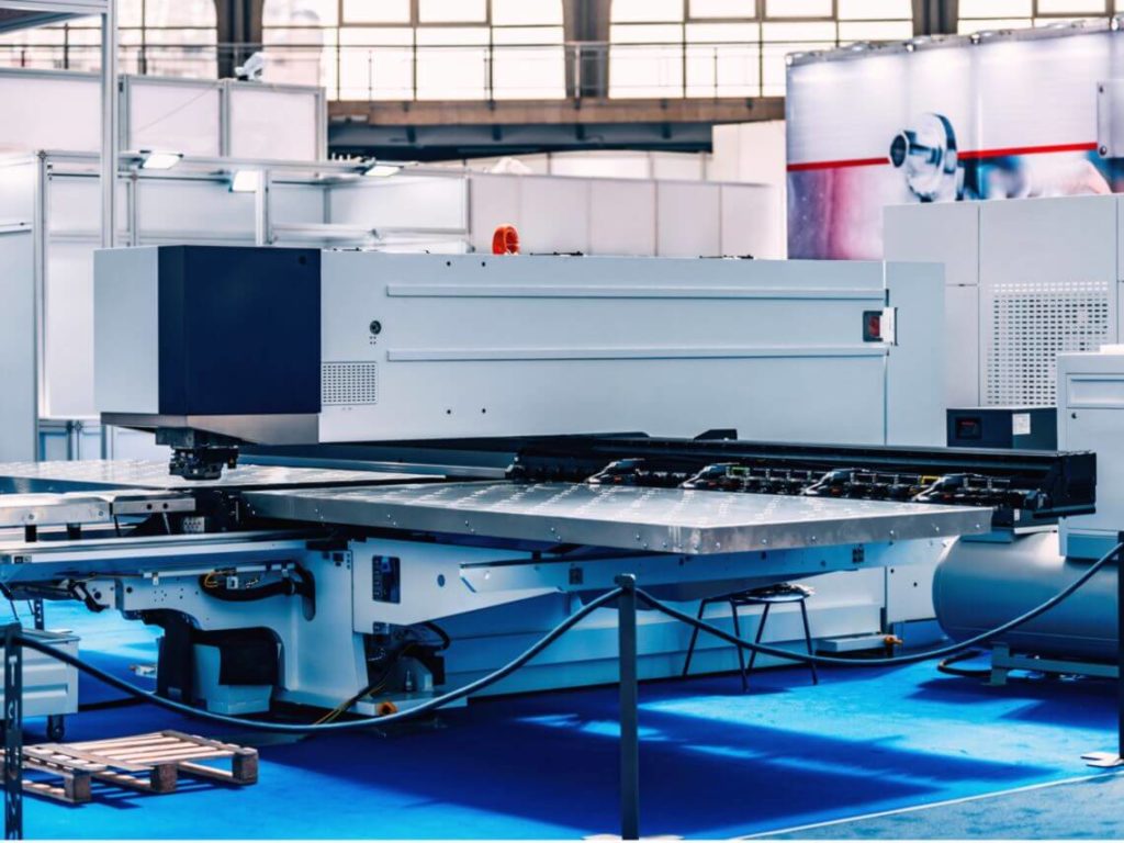 Large white punch laser automation machinery in a manufacturing facility