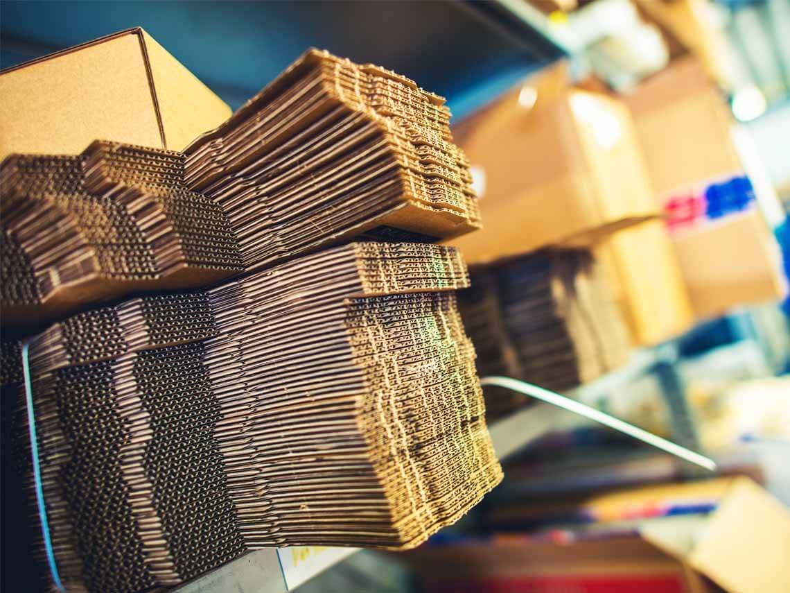 a backstock of boxed shipping materials inside a packaging facility