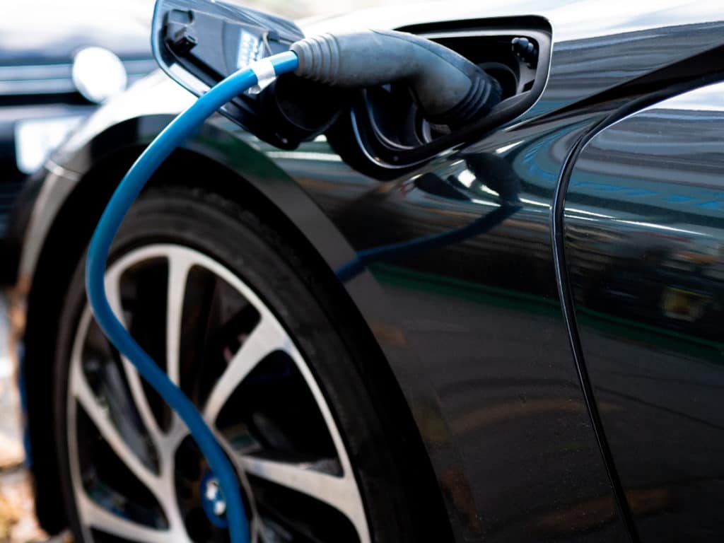 black vehicle at a charging station getting charged