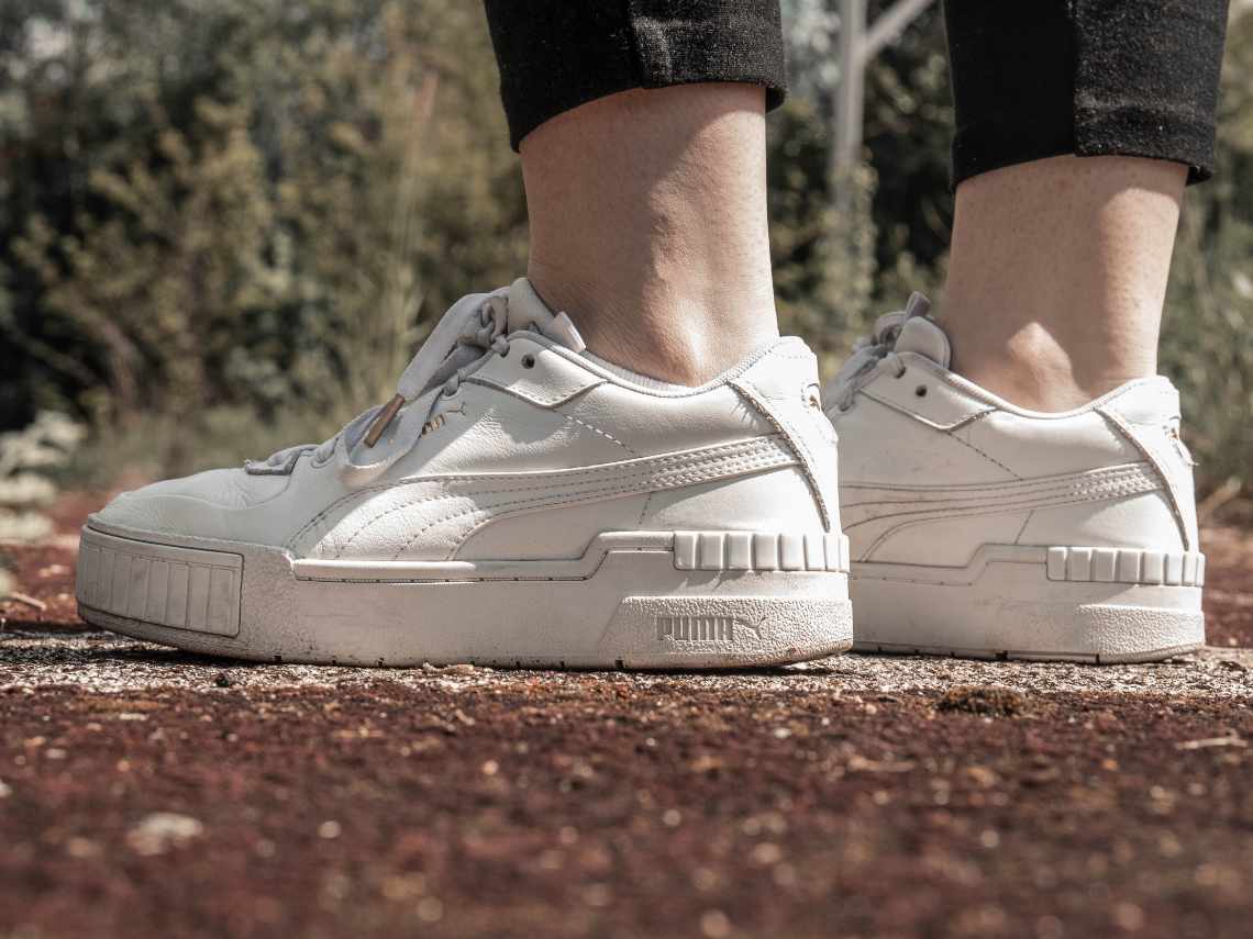 person wearing athletic sneakers outside