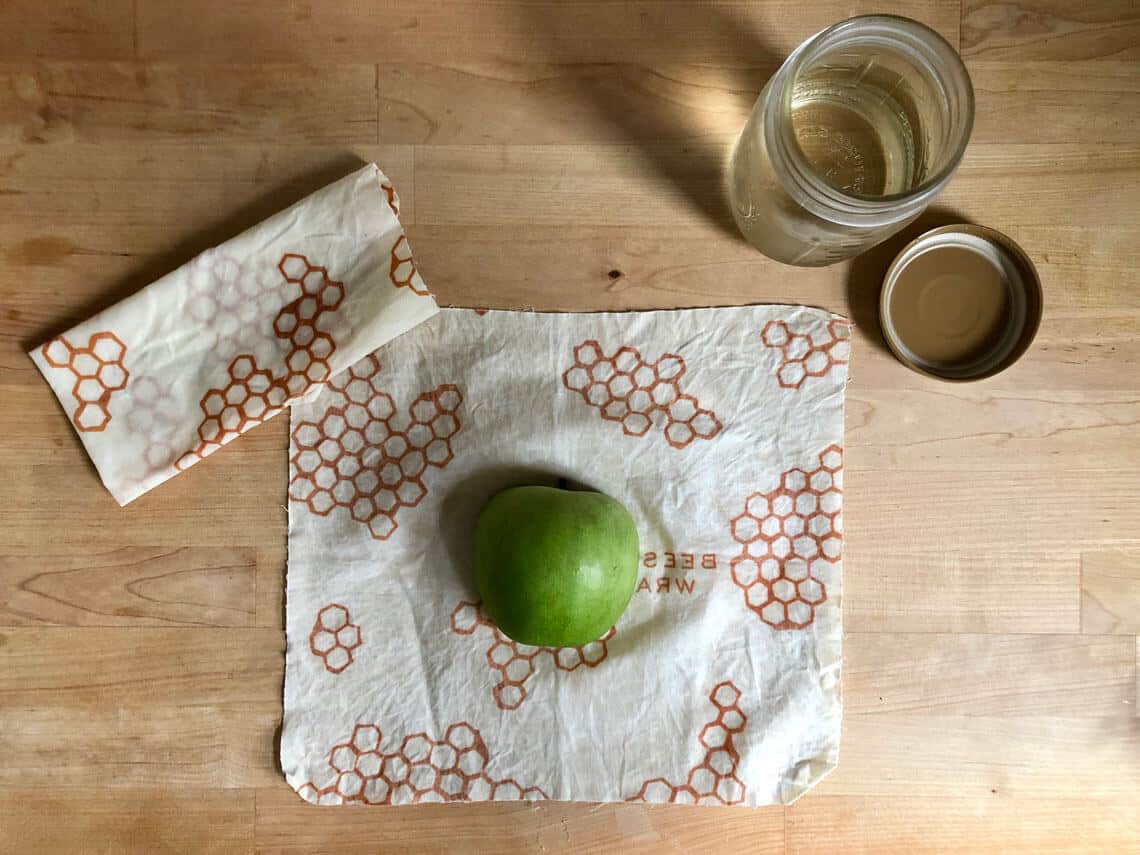 Half an apple on top of beeswax packaging wrap