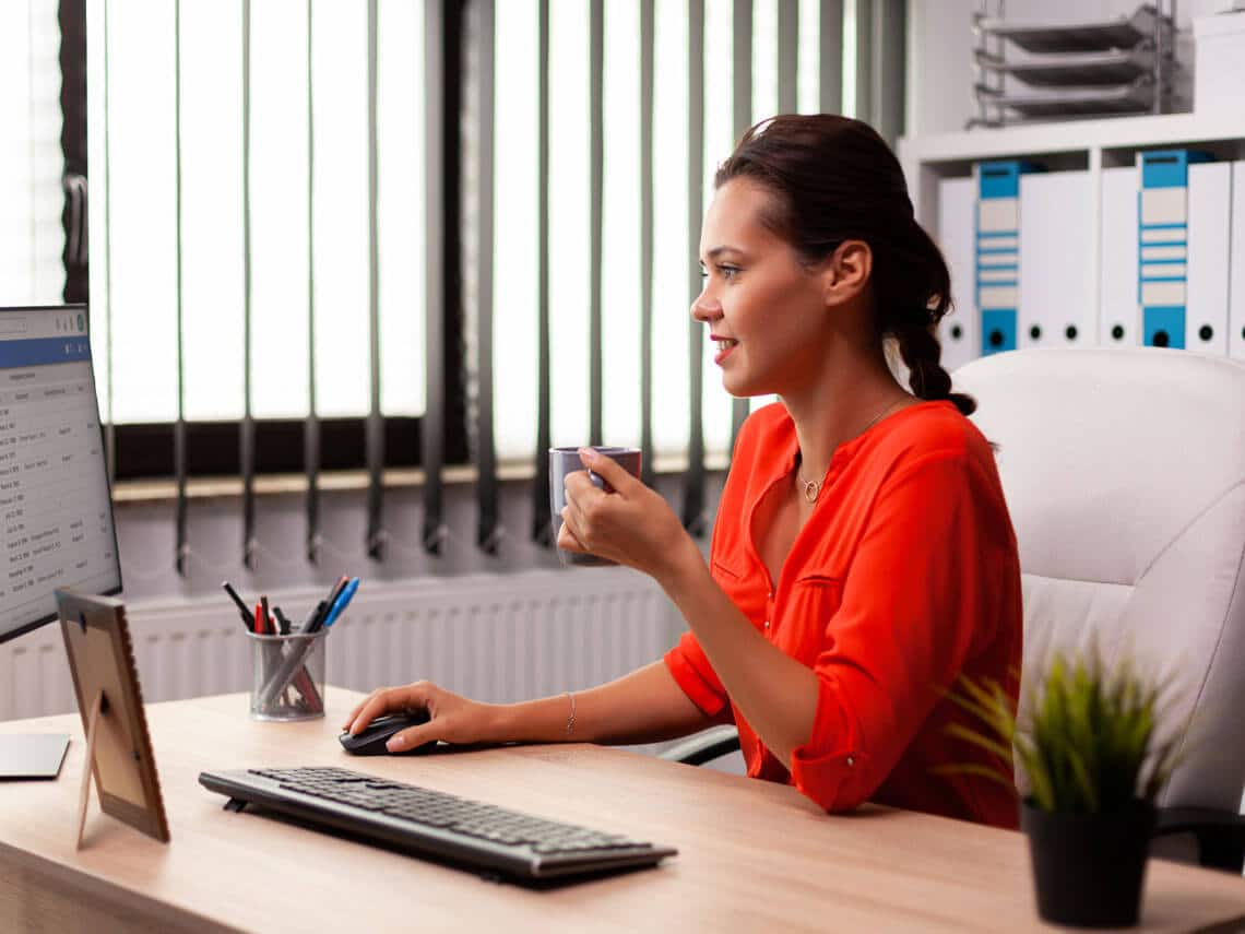 Business woman in workplace looking at Pioneer's innovative extranet on computer